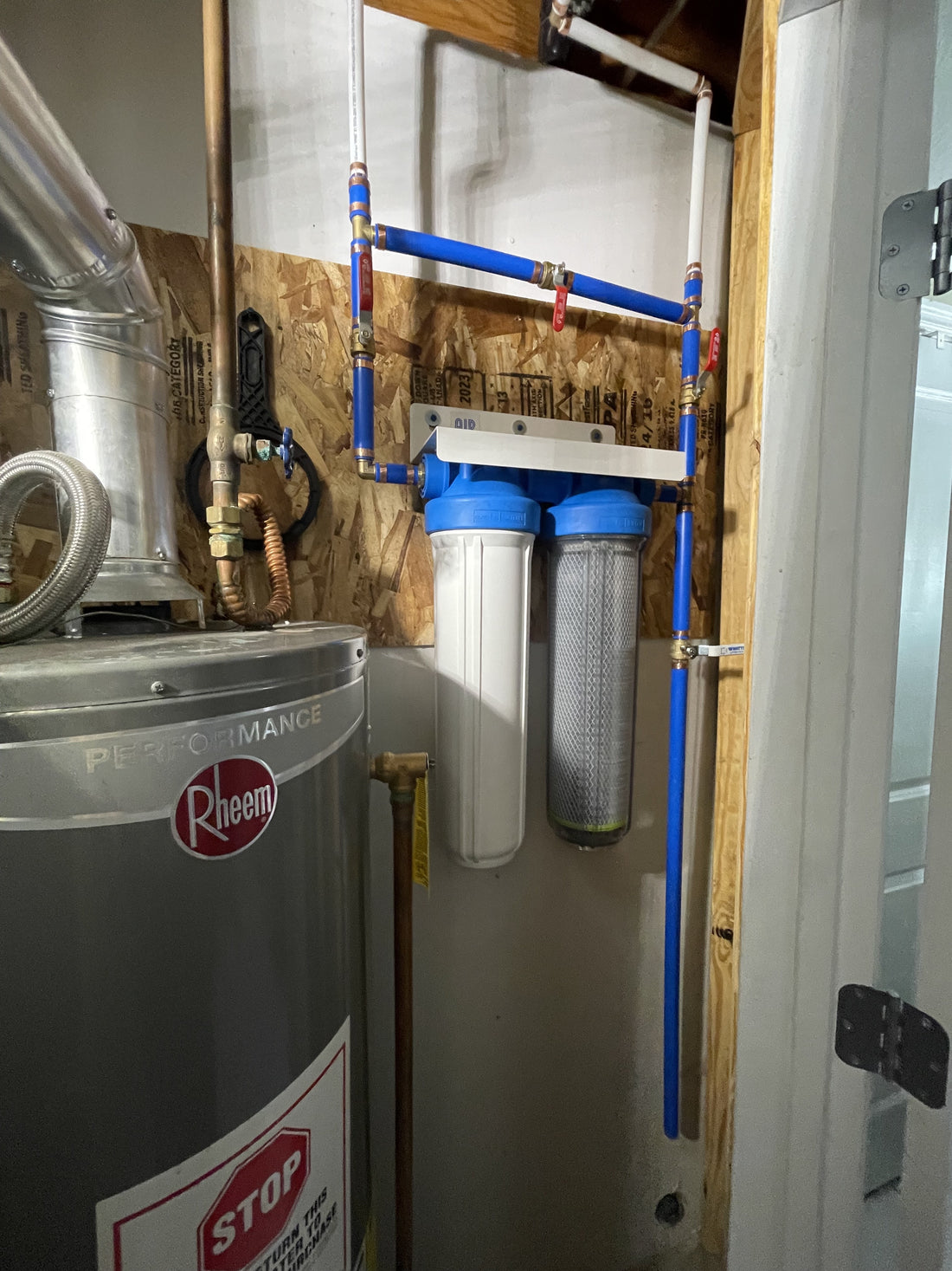 Two NuvoH2O filter housings installed beside a water heater