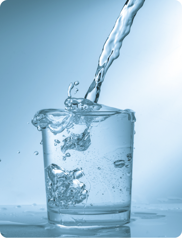 Water pouring into a clear glass