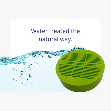 A bright green water treatment puck next to clean splashing water with text stating water treated the natural way