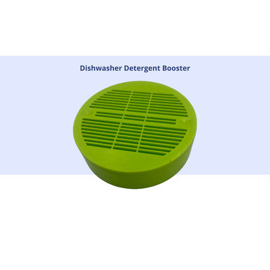 A top view of a circular green plastic dishwasher detergent booster puck against a light blue background