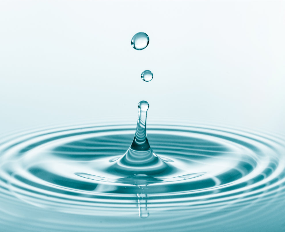 Drop of water falling into still water