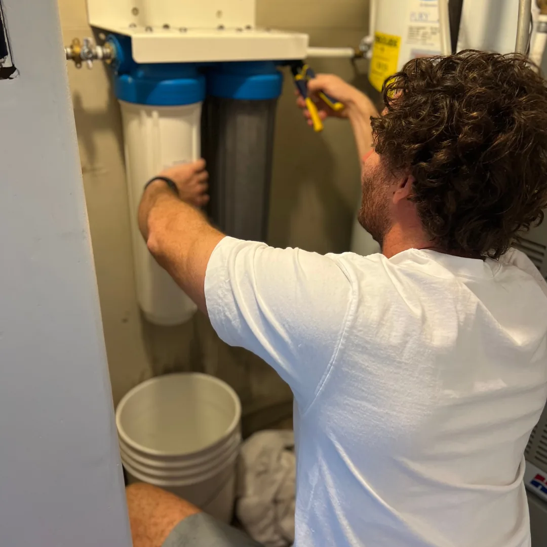 plumber doing maintenance work on a water softener