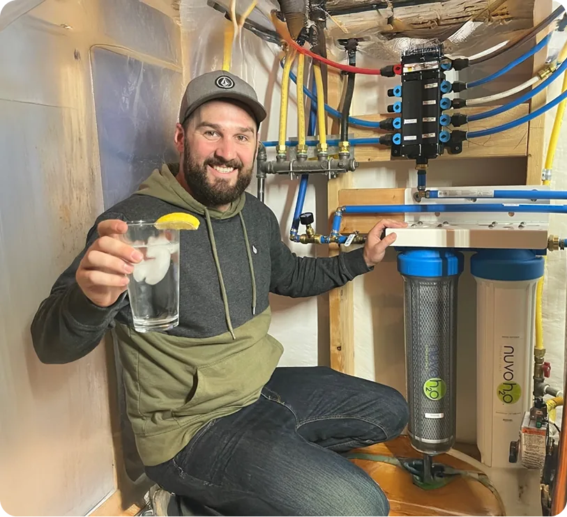 water softer system installed with a man drinking clean water