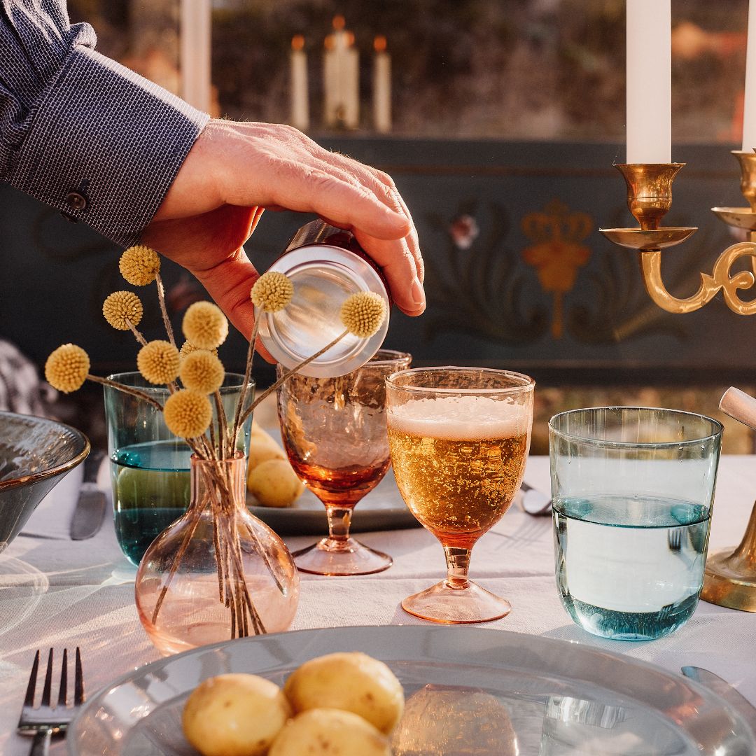 pouring glass of water at dinner