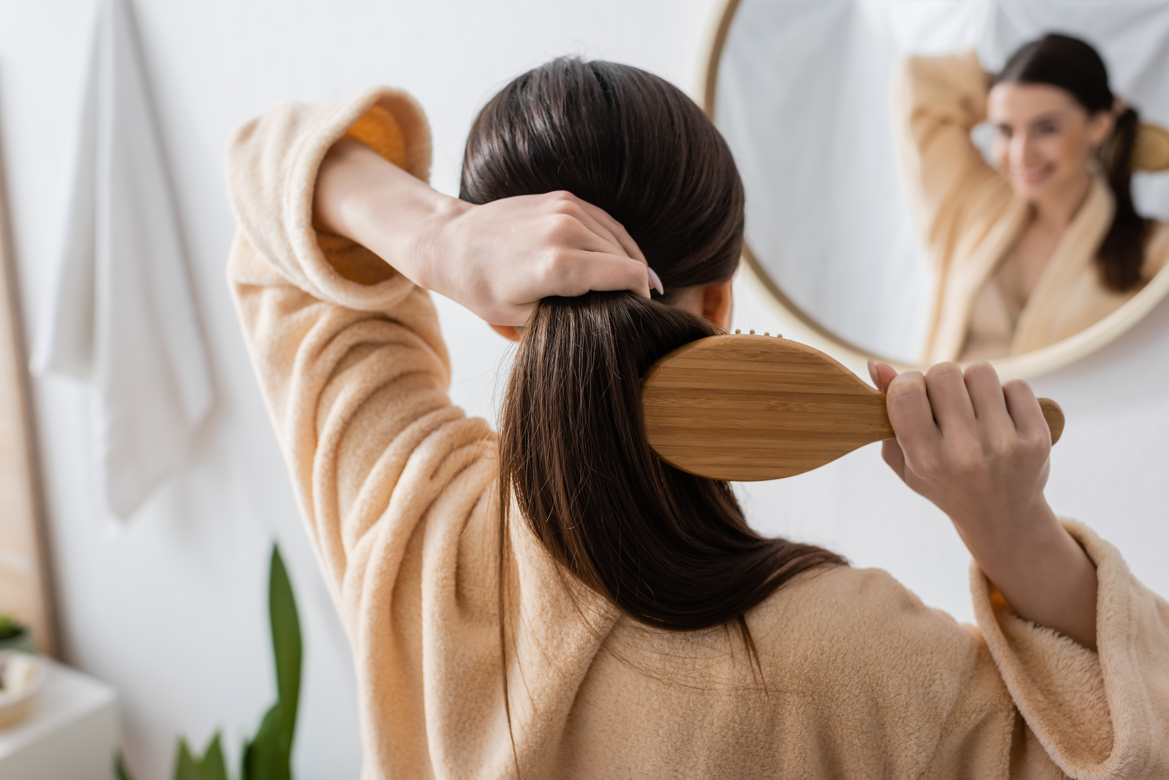 woman brushing her lush soft hair
