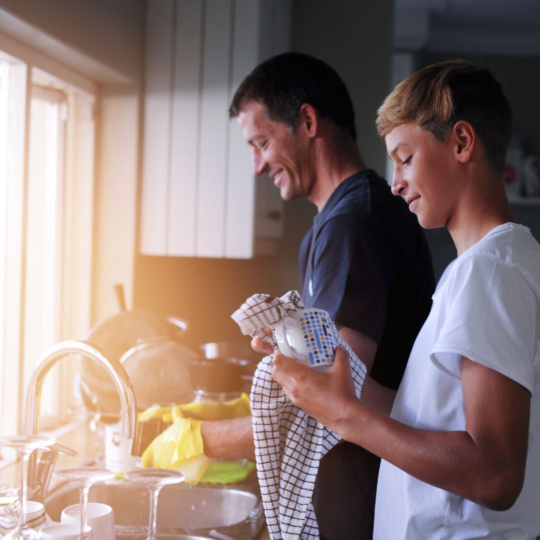 father and son washing dishes