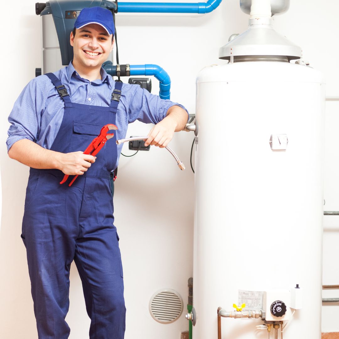 repair person standing in front of a water heater