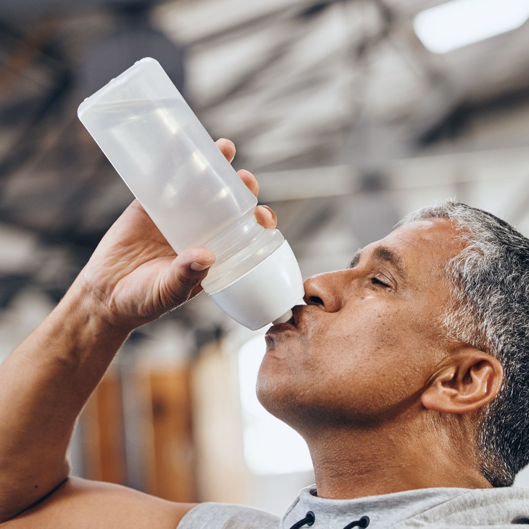 man drinking from water bottle