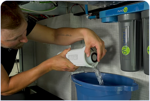 pouring deionized water into a bucket