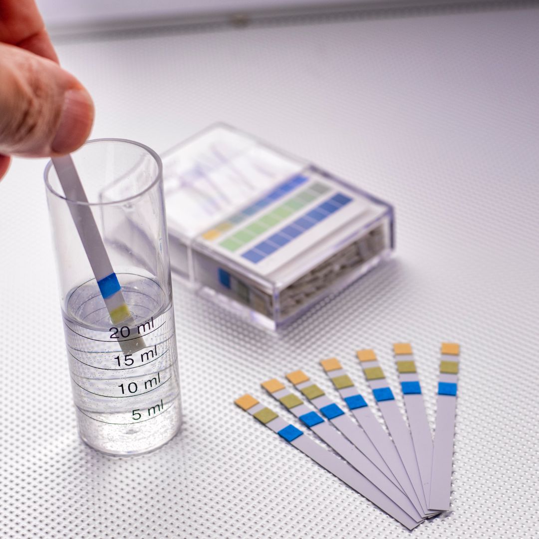 person testing water with test strips