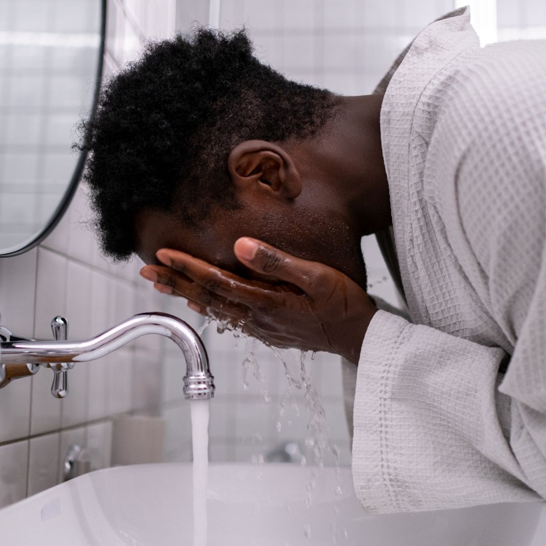 man washing his face