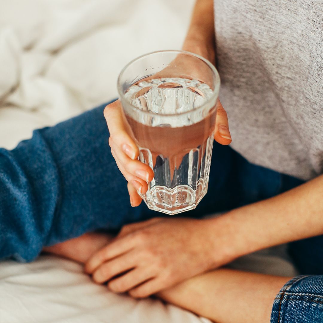 person holding a glass of water