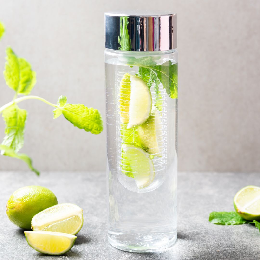 water bottle filled with limes in a diffuser