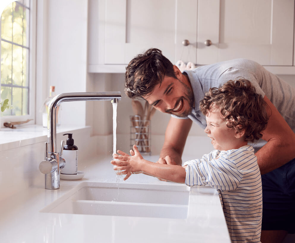father and son washing their hands with soft water