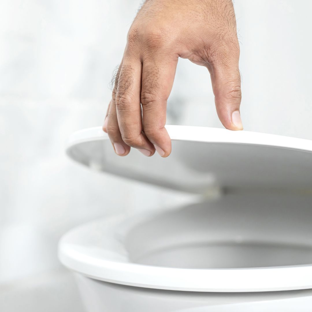 person opening toilet lid