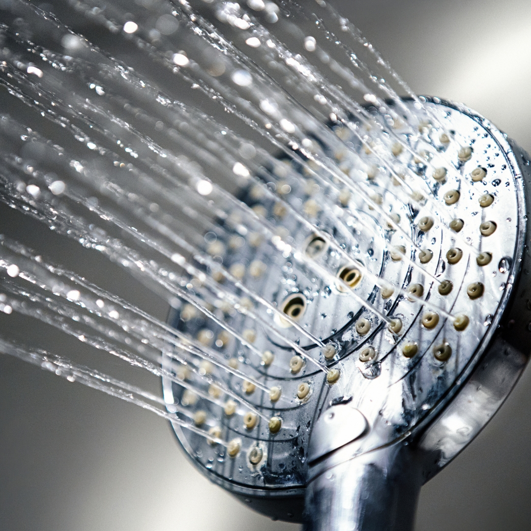 image of a shower head spraying water