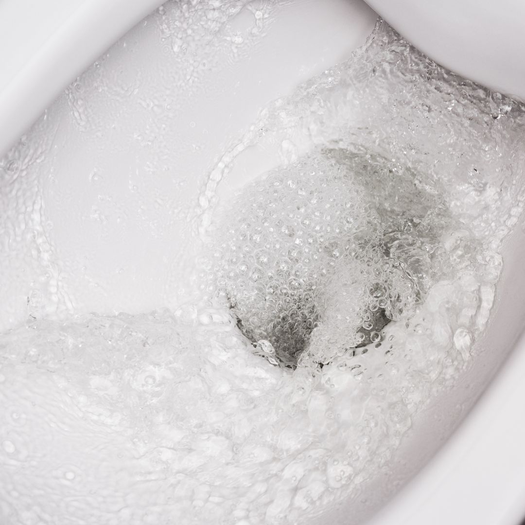 closeup of clean water swirling in a toilet